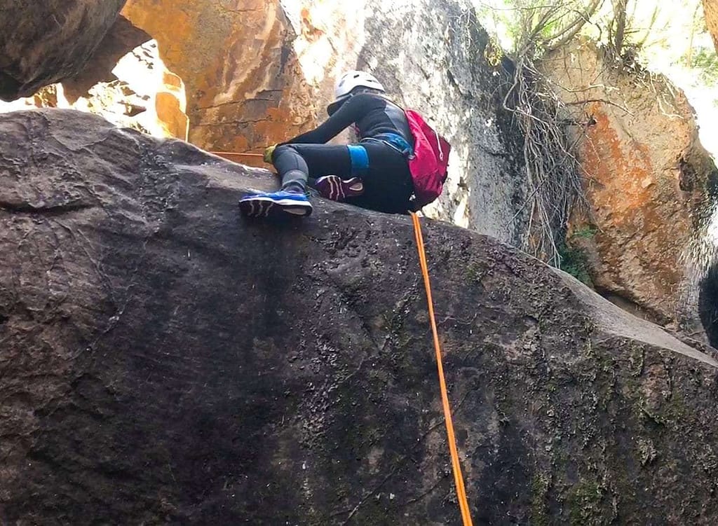 starting a rappel while canyoneering